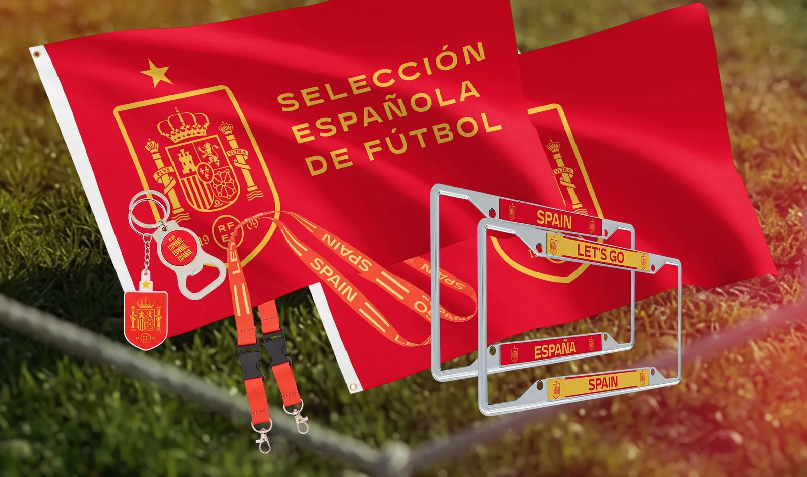 A Spain national team flag, keyring, lanyard and two number plate frames laid on grass